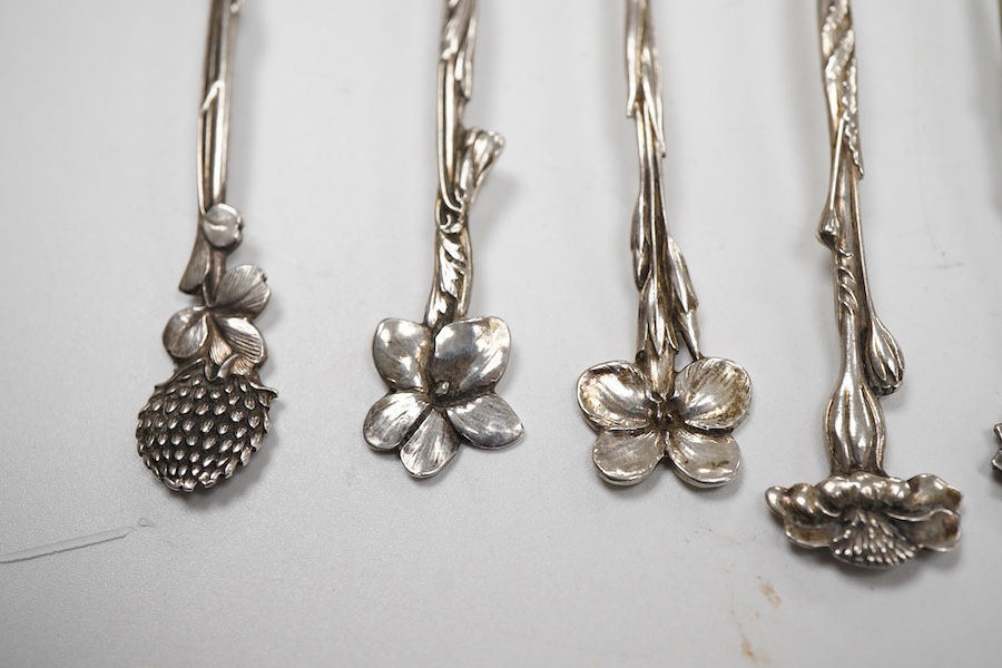 A cased set of six George V silver teaspoons and pair of sugar tongs, by Walker & Hall, Sheffield, 1918, together with a set of ten sterling coffee spoons, with floral terminals, a sterling tea strainer and a boxed Eliza